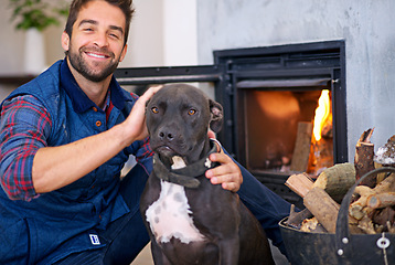 Image showing Fireplace, dog and portrait of man in home with fire for heat, warmth and light in winter. Flame, wood and person with pet bonding with firewood for comfort, cozy and relaxing house in living room