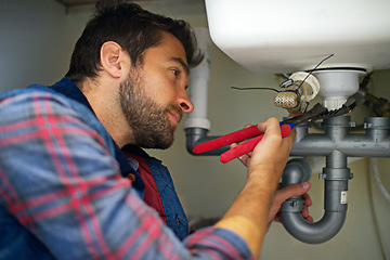 Image showing Man, plumber and wrench with pipe for repair, service or fix in home maintenance or indoor leak. Young male person, handyman or plumbing professional with tool for water or sink damage at the house