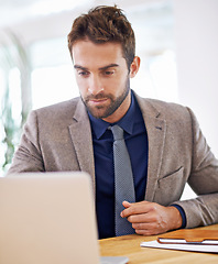 Image showing Businessman, laptop and working in office by desk, professional and productivity on internet in workplace. Hr consultant, computer and online research for recruitment and networking on social network