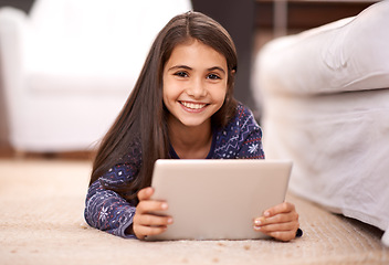 Image showing Floor, portrait or child with tablet for streaming, playing games or watching fun videos on movie website. Girl, house or happy kid with technology to download online or social media app to relax