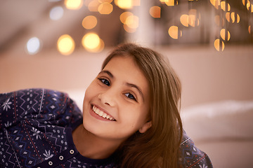 Image showing Smile, happy and portrait of child with lights for relaxing, resting and calm in bedroom at night. Youth, home and face of young girl with fairy light for childhood memory, peaceful and happiness