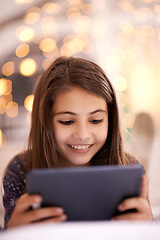 Image showing Home, night or kid with tablet for movies, playing games or watching fun videos on streaming website. Girl, house or young female child with technology to download online or social media app to relax