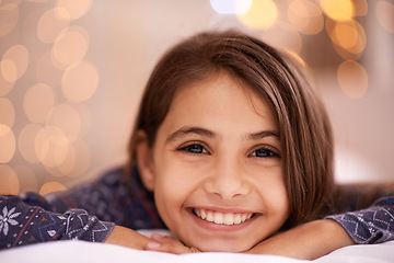 Image showing Kids, portrait and happy girl relax in a house for vacation, resting or break with light and bokeh background. Face, smile and innocent female child person in a living room for holiday or weekend