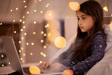 Image showing Home, bedroom or kid with laptop for streaming, playing games or watching videos on a movie website. Research, night or female child with technology to download online or social media app to relax