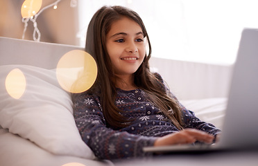 Image showing Movies, night or kid with laptop for streaming, playing games and watching videos on a film website. Smile, house or happy female child with technology to download online or social media app to relax