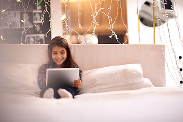 Image showing Girl, child and tablet in bed, happy and relax with tech, ebook for reading and social media at home. Website, cartoon or storytelling app with internet, browse and digital platform for gaming