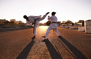 Image showing People, karate and fitness with personal trainer in city street for self defense, fighting technique or style. Man and woman fighter or athlete in training, martial arts or kick boxing in urban town