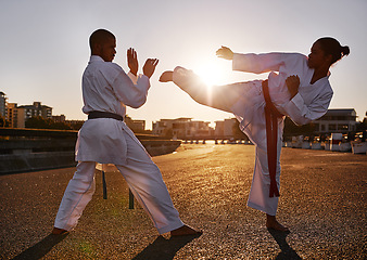 Image showing People, karate and martial arts with personal trainer for self defense, technique or style in city street. Man and woman fighter or athlete in fitness training, fighting or kick boxing in urban town