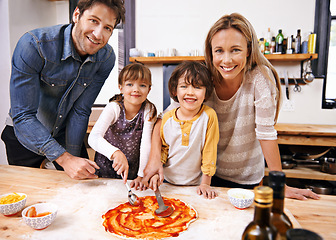 Image showing Parents, kids and portrait for cooking pizza with sauce, learning or helping hand for development in kitchen. Mother, father and children with dough, teaching and support with bonding in family house