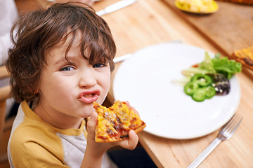 Image showing Boy, child and pizza in portrait at dinner table for eating, food and relax on holiday in family house. Kid, happy and playful in dining room for lunch with nutrition, diet and home for funny face