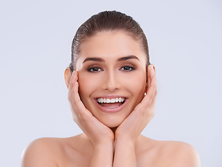 Image showing Beauty, skincare and portrait of woman with hands on face, smile and benefits of cosmetics in studio. Dermatology, health and happy girl with natural makeup, glow and skin care on white background
