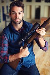 Image showing Hunter, pride and portrait of man with gun for game shooting, adventure and hobby with confidence. Sports, trophy hunting and serious person in cabin with rifle, equipment and weapon gear in home