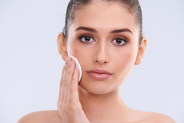 Image showing Face, woman and cotton pad for cleaning makeup from skin, cosmetics and beauty product on white background. Skincare routine, cleanse and wipe in portrait, dermatology and facial treatment in studio