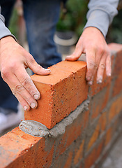Image showing Building, construction and bricklayer with hands and cement, stacked bricks for wall foundation. Industrial worker, handyman or masonry for maintenance with contractor, project on site with foreman