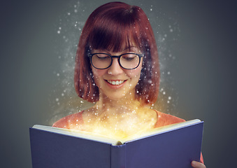 Image showing Glowing pages, book and woman with a story, fantasy and education on grey studio background. Person, reader and girl with a novel and literature with knowledge or creativity with glasses or astrology