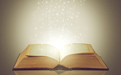 Image showing Magic, glowing pages and story with book, sparkle and literature on a grey studio background. Empty, education and art with creativity and lights with novel and knowledge with astrology and fantasy