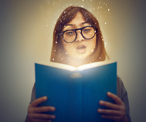 Image showing Glowing pages, book and woman with a story, reading and education on grey studio background. Person, model and girl with a novel and literature with knowledge and creativity with fantasy or astrology