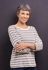 Image showing Portrait, happy and senior woman with arms crossed, retirement and cheerful on a grey studio background. Face, elderly person and mockup space with old lady and pensioner with joy, calm and smile