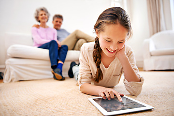 Image showing Relax, kid or girl with tablet for elearning or studying for remote education on carpet at home. Family, grandfather or grandmother with a happy child reading ebook or streaming video or movie