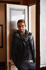 Image showing Man, portrait and fashion in house for style and clothes for bold and trendy indoor. Young person, smile and handsome with scarf and jacket for winter wear and comfort for edgy and aesthetic