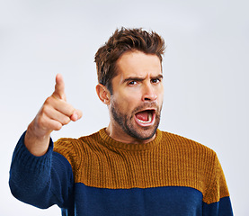 Image showing Frustrated man, portrait and pointing to you with shout for choice, pick or rage on a white studio background. Angry male person or upset model yelling or screaming with mood or attitude on mockup