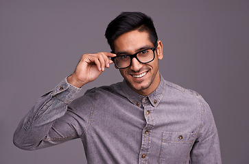 Image showing Happy man, face and glasses in studio for eye care, vision and new frame with confidence on a gray background. Portrait of a young person or cool model in spectacles, eyewear and test for lens check