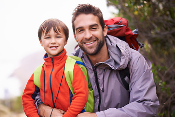 Image showing Father, child and portrait with hiking, backpack and travel with smile and happy in nature. Kid, adventure and mountain with love, trust and bonding together with family and journey for holiday