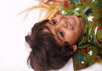 Image showing Children, thinking and boy on a floor happy, chilling or imagine, playful or brainstorming at home. Night, smile and curious Indian kid in a living room in India with bedtime fun, memory or fantasy