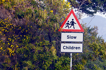 Image showing Road sign, pedestrian and slow children with mistake for grammar, joke and comic text for walking in neighborhood. Asphalt, error and funny signage with graphic, language and wrong warning in town