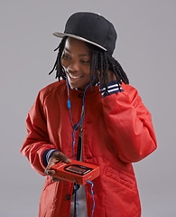 Image showing Music, happy and child on gray background with cassette for listening to song, audio and radio. Fashion, youth and young African boy with retro tech for track playlist in trendy clothes in studio