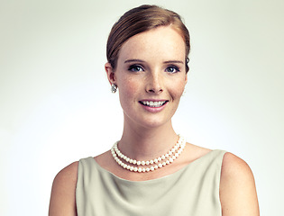 Image showing Portrait, fashion and beauty of happy woman in studio isolated on a gray background. Face, freckles and skin of young person in vintage clothes for style, retro or elegance with necklace in Ireland