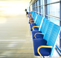 Image showing Chair, row and interior in airport for travel, aircraft and flight in building with design in futuristic architecture. Modern, urban and editorial with walls for movement, destination and travelers