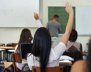 Image showing Students, question and hands up to lecturer in classroom, lesson and subject quiz in university. People, diversity and college for learning or education, teaching and answer of knowledge on campus