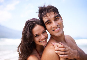 Image showing Hug, happy and portrait of couple by beach on vacation, adventure or holiday for romantic travel. Smile, love and young man and woman embracing by ocean for tropical outdoor anniversary weekend trip.