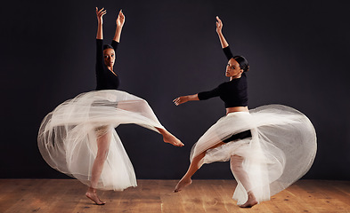 Image showing Ballet, black people and ballerina in studio for dance routine, spinning and creative performance. Contemporary, dancing and young women for elegant art, movement and practice with dark background