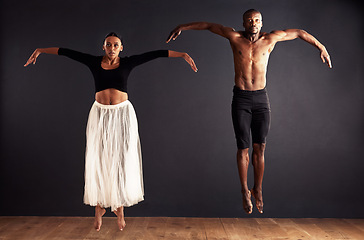 Image showing Performance, portrait and duet of people dancing, creative and art of body, moving and passion. Black background, man and woman with pride, confident and ballet with balance in stage or floor