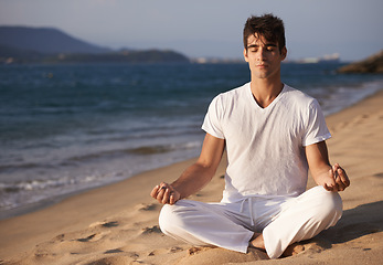 Image showing Meditation, lotus and man on beach, mindfulness and zen with fresh air for calm and eyes closed outdoor. Ocean, seashore and travel with yoga for health, peace of mind and holistic healing for aura