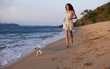 Image showing Woman, running on beach and dog with travel for ocean, vacation in Cancun and nature with pet. Fresh air, wellness and energy with puppy outdoor, happiness for adventure and tourism on island