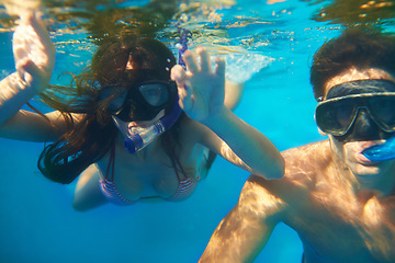 Image showing Scuba diving, underwater or couple swimming to explore for marine adventure, hobby or vacation activity. Mask, divers or people at a beach or ocean for travel, tropical environment or outdoor holiday