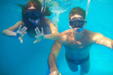 Image showing Scuba diving, underwater or couple swimming on holiday to explore for marine adventure, hobby or vacation. Mask, divers or people at sea or ocean for travel, tropical environment or outdoor activity