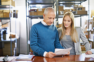 Image showing Document, warehouse and team in discussion for shipping, reading or distribution with senior manager. Factory, paperwork or logistics for inventory, stock or collaboration of business people at table