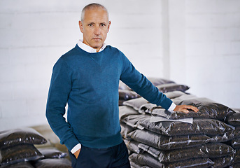 Image showing Coffee, storage and portrait of man with bags for distribution, quality control and confident in warehouse. Export, manufacturing and proud entrepreneur with beans at factory for sustainable business