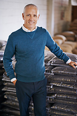 Image showing Coffee beans, storage and portrait of man with bags for distribution, quality control and confident in warehouse. Export, manufacturing and entrepreneur at factory for sustainable logistics business