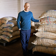 Image showing Coffee beans, warehouse and portrait of man with bags for distribution, quality control and confident logistics. Export, manufacturing and entrepreneur at factory for sustainable business in Colombia