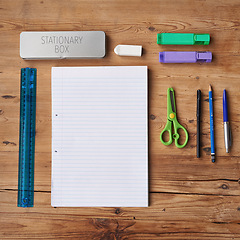 Image showing Desk, notebook and stationery for school project or assignment on creative art, design and drawing. Wooden table, supplies and pen for writing exams or test with blank page for ideas and planning