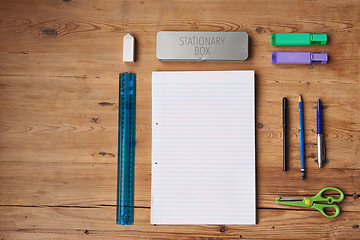 Image showing Table, notebook and stationery for school project or assignment on creative art, design and drawing. Wooden desk, supplies and pen for writing exams or test with blank page for ideas and planning