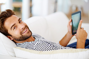 Image showing Couch, portrait or man with tablet for streaming movies or watching fun videos on a film website in home. Smile, online or happy person with technology to download on app or reading ebook to relax