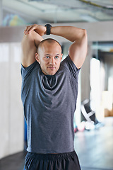 Image showing Athlete, man and stretching with goal for workout, exercise and fitness with smile for competition. Male person, healthcare and wellness with sport as hobby, daily routine and cardio with happiness