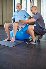 Image showing Physiotherapist, support and senior man with ball, training and elderly help for care. Men, gym and exercise for health, wellness and coaching with osteoporosis for mature rehab and wellbeing