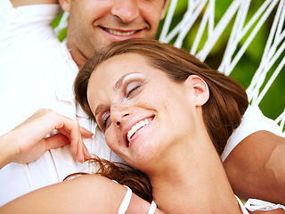 Image showing Love, happy couple or relax on hammock in nature, peace or lazy vacation in summer on tropical island. Young man, woman and wellness at tropical resort, sleeping and holiday for honeymoon outdoor